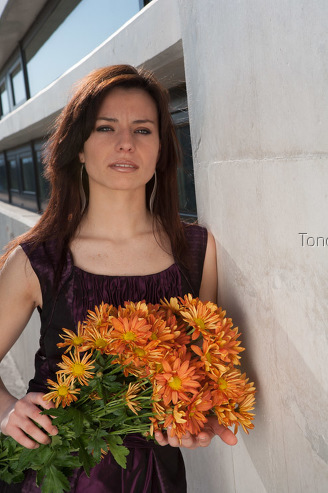 Young woman holding bunch of gerber daisies, portrait